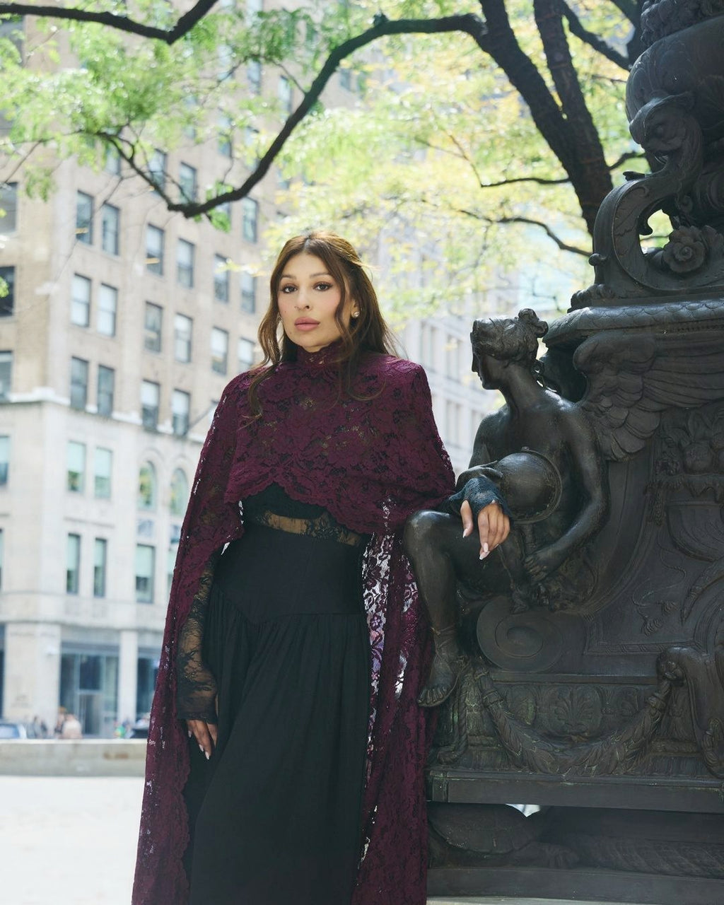 Oxblood Chantilly lace Femme Cape and corset set, full length, outdoors in New York City.