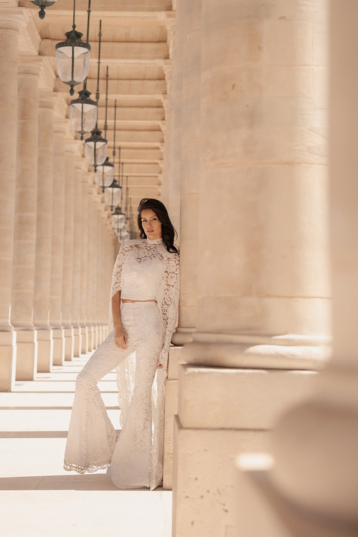 White lace wide-leg trousers with a white lace top, full length, front view.