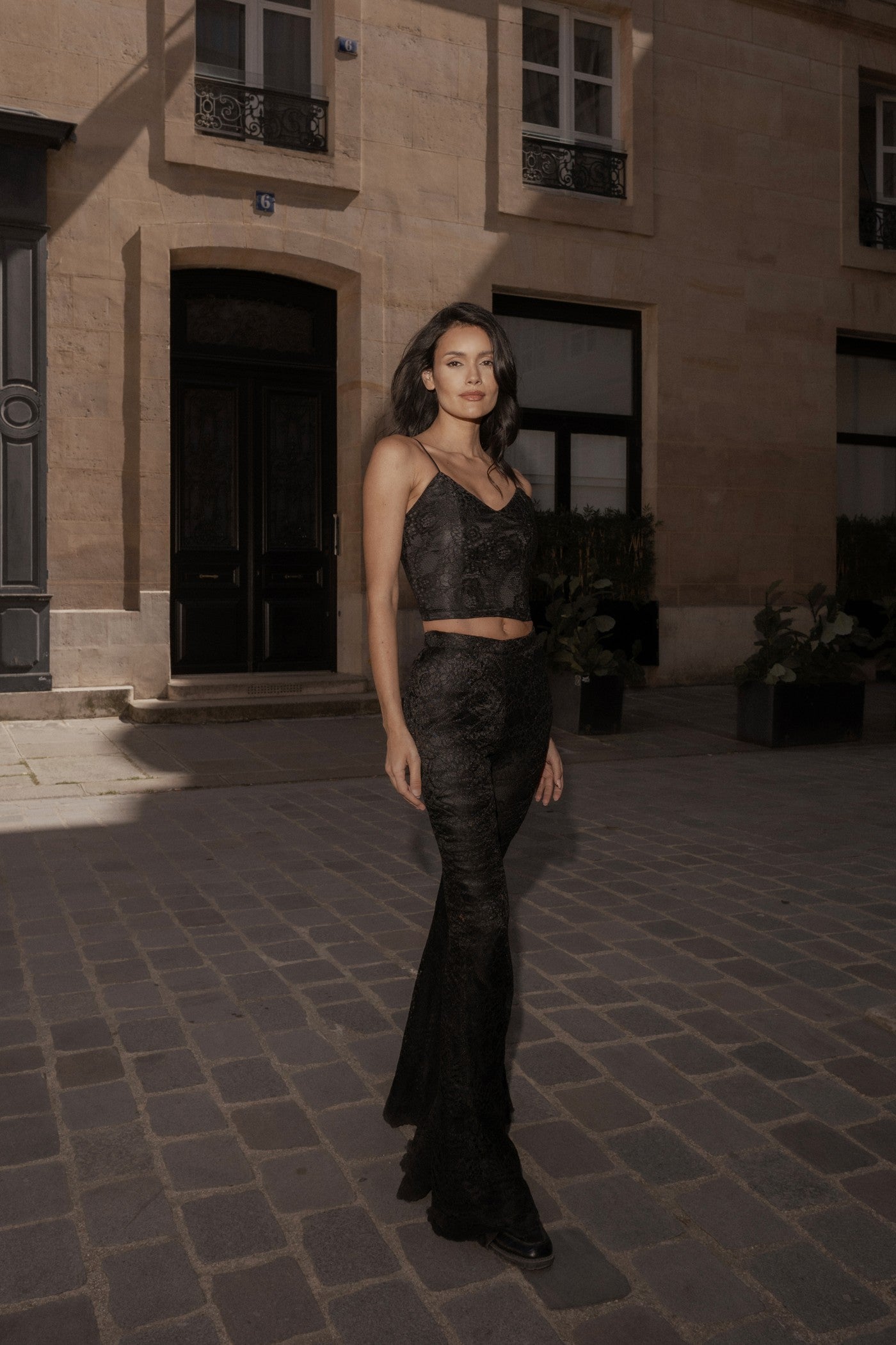 Black Femme Pants worn with the Noir Femme Cape, Louvre courtyard, Paris